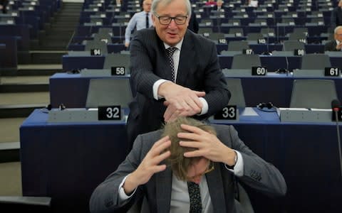 European Commission President Juncker jokes with European Union's chief Brexit negotiator Guy Verhofstadt - Credit: Reuters