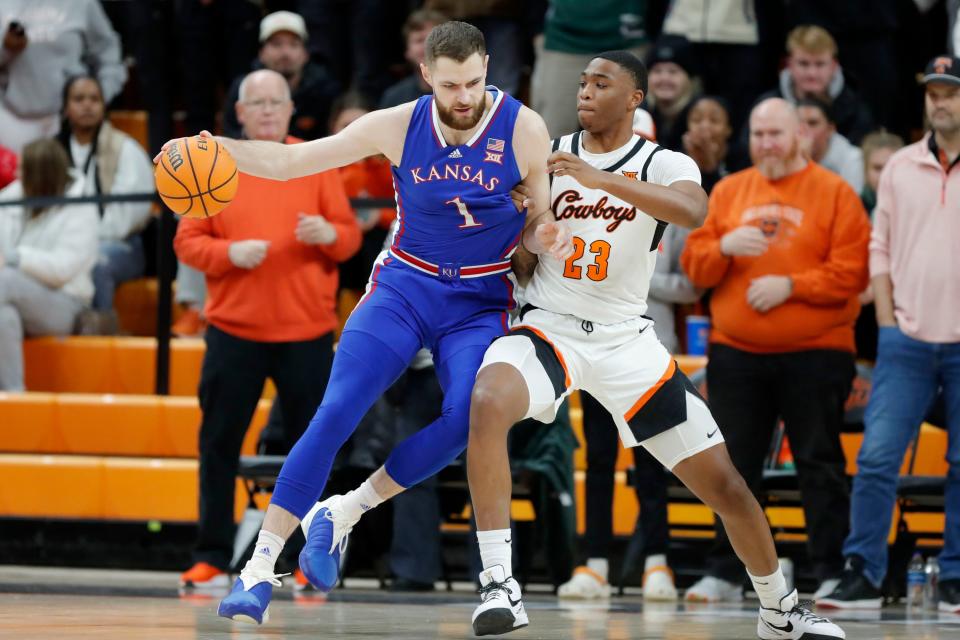 Oklahoma State Cowboys center Brandon Garrison (23) defends Kansas Jayhawks center Hunter Dickinson (1) during a college basketball game between the Oklahoma State University Cowboys (OSU) and the Kansas Jayhawks at Gallagher-Iba Arena in Stillwater, Okla., Tuesday, Jan. 16, 2024.