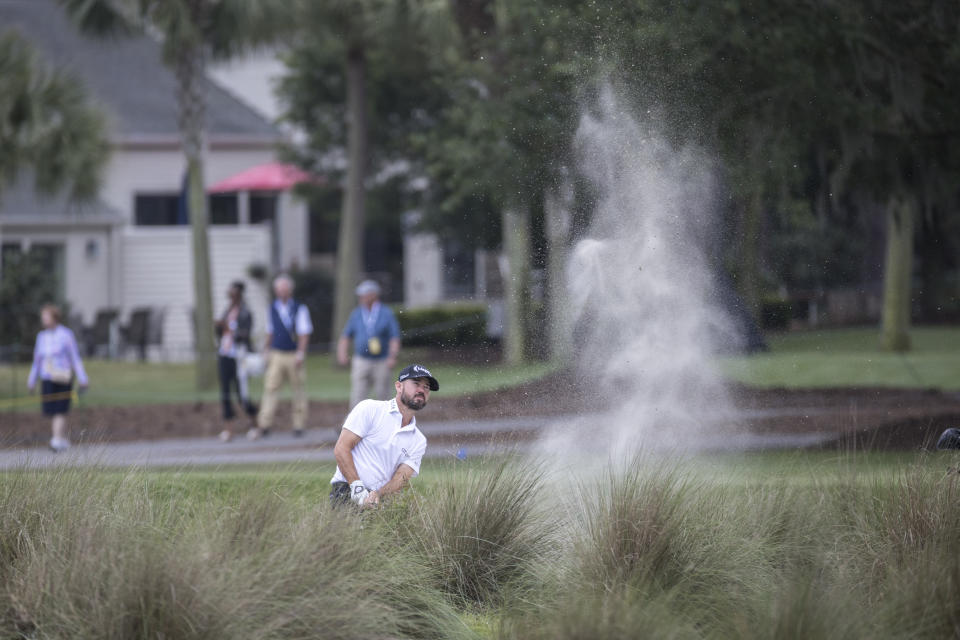 Brian Harman watches his shot out of a bunker on the 16th fairway during the first round of the RBC Heritage golf tournament, Thursday, April 13, 2023, in Hilton Head Island, S.C. (AP Photo/Stephen B. Morton)