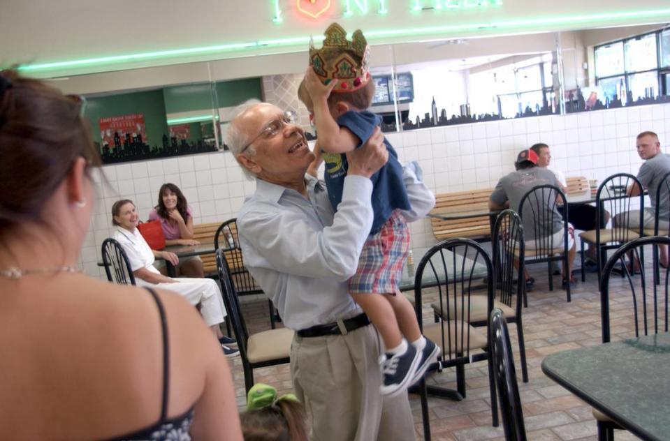 In this 2004 file photo, Assad Meymandi greets his grandchild Vincent Meymandi, 2, while dinning at I Love NY Pizza in Raleigh.