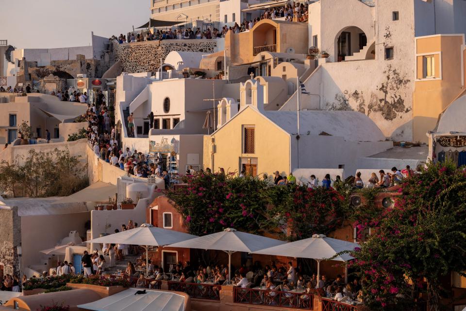 Tourists wait to view Santorini’s famed sunset, on Santorini, Greece, July 25, 2024.