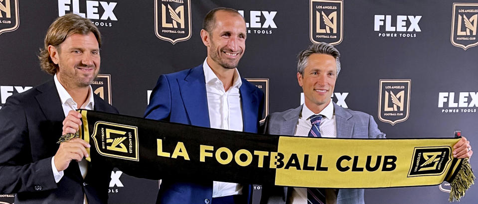 Agent Davide Lippi, left; Giorgio Chiellini, center; and Los Angeles FC co-president/general manager John Thorrington pose for a photo in Los Angeles on Wednesday, June 29, 2022. Chiellini is coming to the United States and Major League Soccer following 15 years with Juventus in Italy's Serie A. (AP Photo/Joe Reedy)