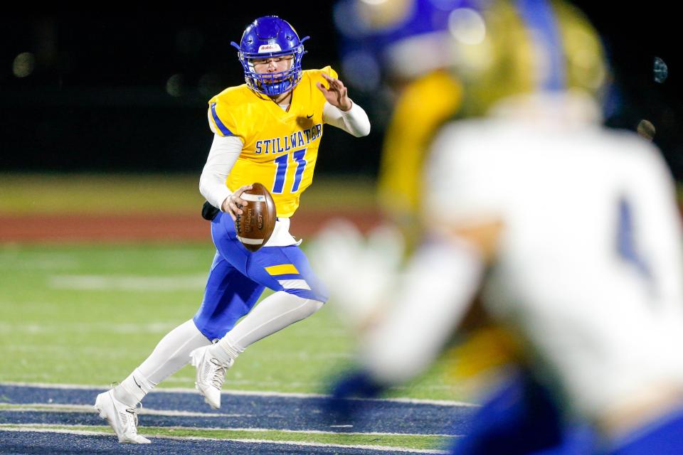 Stillwater’s Chance Acord (11) scrambles with the ball during an Oklahoma high school semifinal football game between Stillwater and Choctaw in Edmond, Okla., on Friday, Nov. 24, 2023.