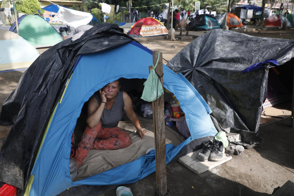 A migrant rests in a tent at a camp as she waits for a Honduras Migration transit permit to continue her way north to Guatemala, and hopefully make it to the Mexico-United States border, in Danlí, Honduras, Wednesday, Oct. 11, 2023. According to Honduras' immigration agency, at the country's southern border with Nicaragua, more than 18,300 migrants entered the town last week. (AP Photo/Elmer Martinez)