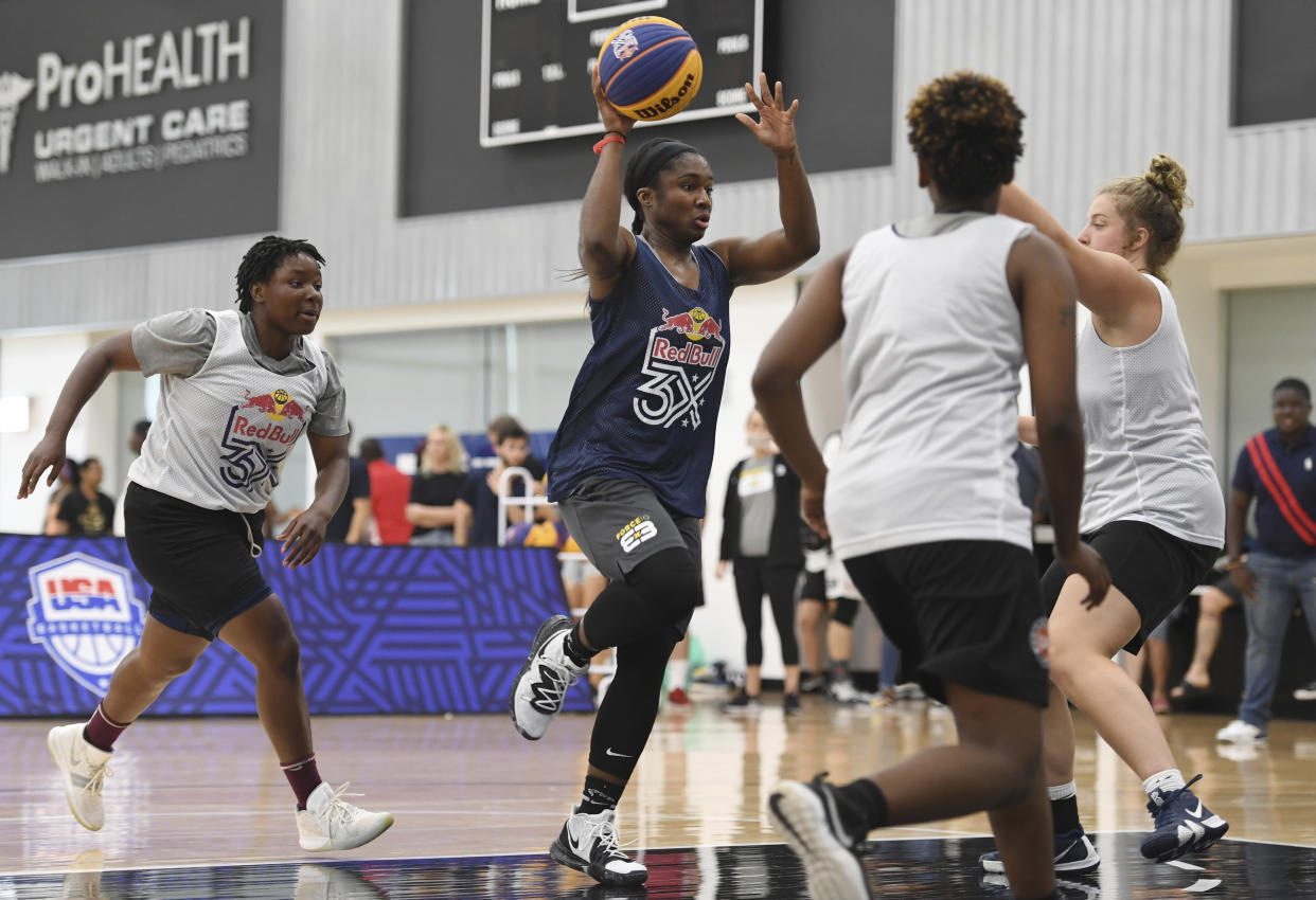 Former Ohio State standout Linnae Harper, center, competes for Force 10 in the Red Bull 3-on-3 basketball tournament in New York. (AP Photo/Sarah Stier)