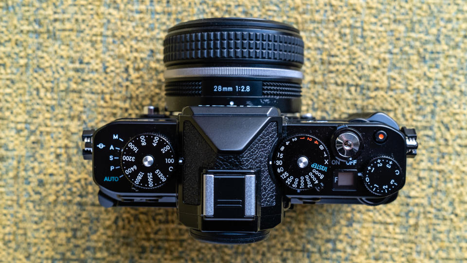 Nikon Z f camera on a vintage-style yellow chair