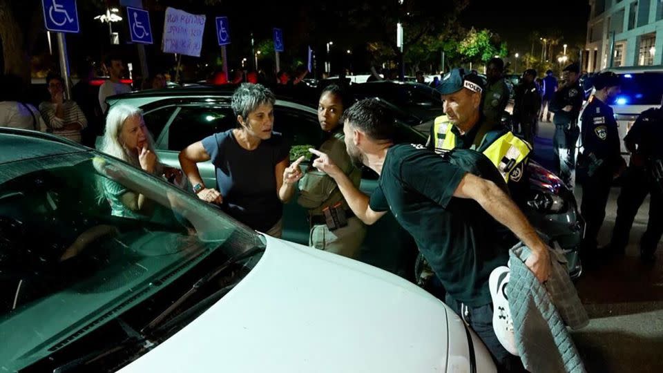 Protesters and an anti-protester argue outside an event attended by Ben-Gvir in Caesarea, Israel, in November 2023. - William Bonnett/CNN