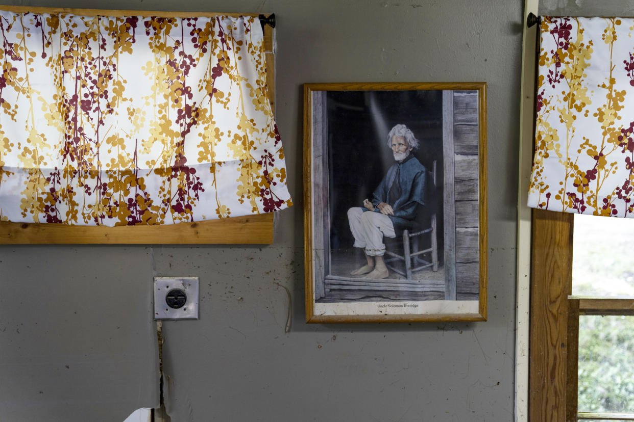 Image: A picture of Uncle Solomon Everidge, who donated the land for the Hindman Settlement School in 1902, is covered in mud on Aug. 2, 2022. (Michael Swensen for NBC News)