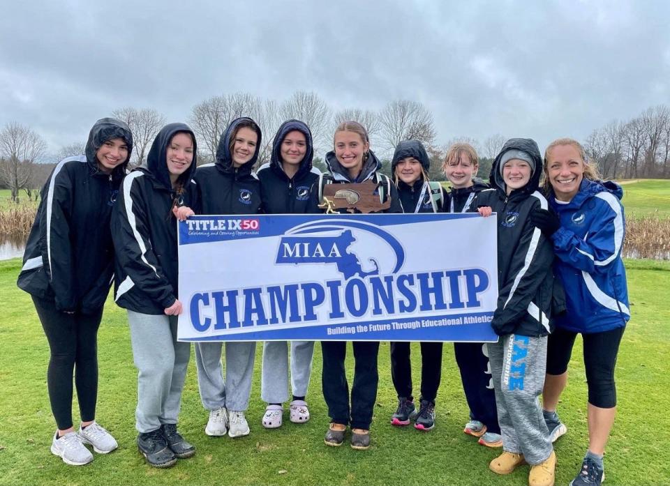 Members of the Lunenburg girls' cross-country team celebrate the Division 3B championship on Sunday at Gardner Municipal Golf Course.