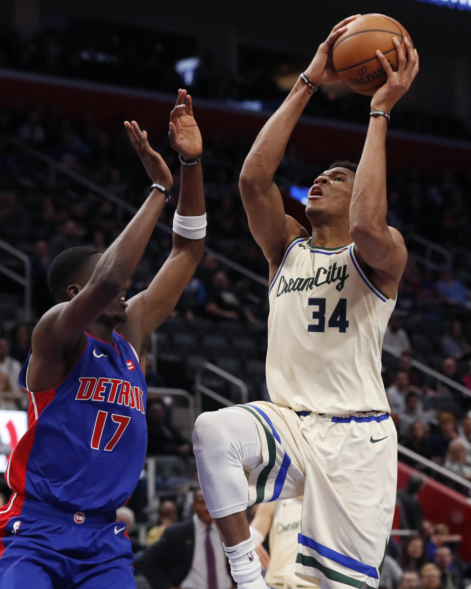 Milwaukee Bucks forward Giannis Antetokounmpo (34) attempts a layup as Detroit Pistons guard Tony Snell (17) defends during the first half of an NBA basketball game, Wednesday, Dec. 4, 2019, in Detroit. (AP Photo/Carlos Osorio)