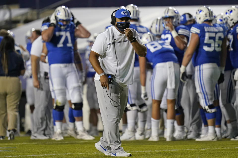 BYU coach Kalani Sitake speaks with officials during the first half of the team's NCAA college football game against Louisiana Tech on Friday, Oct. 2, 2020, in Provo, Utah. (AP Photo/Rick Bowmer, Pool)