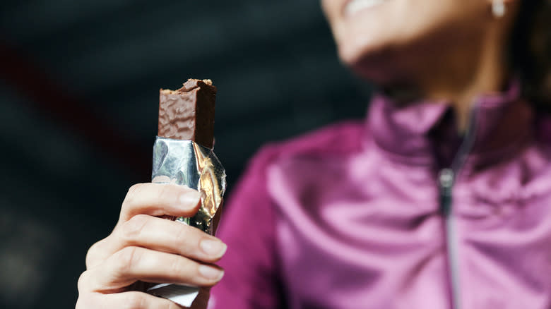 Woman eating protein bar