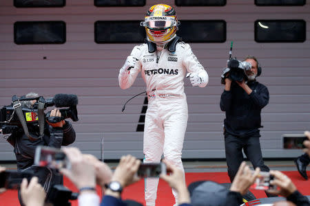 Formula One - F1 - Chinese Grand Prix - Shanghai, China - 09/04/17 - Mercedes driver Lewis Hamilton of Britain celebrates after winning the Chinese Grand Prix at the Shanghai International Circuit. REUTERS/Aly Song