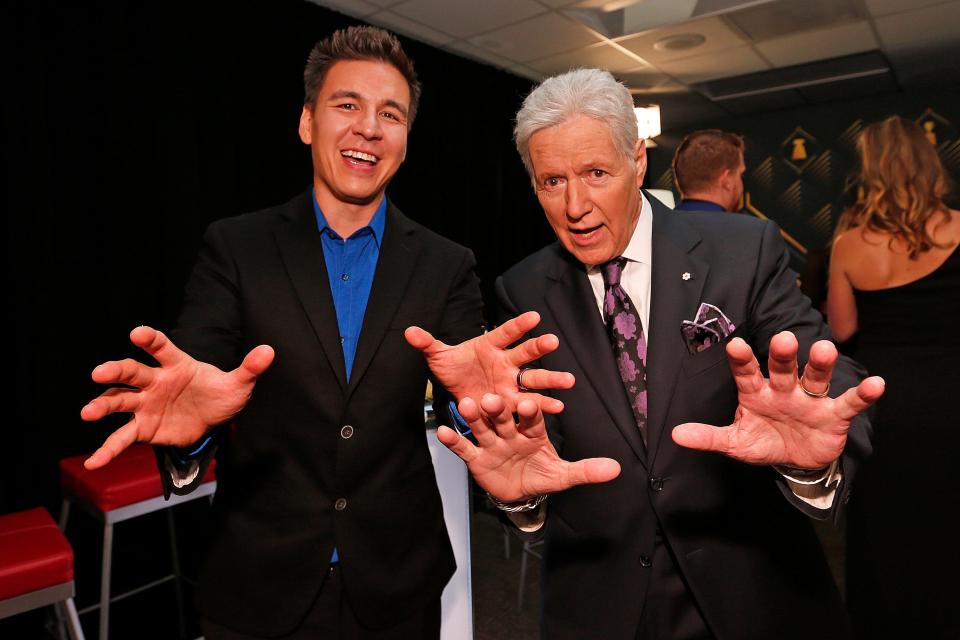 Alex Trebek poses with "Jeopardy!" champion James Holzhauer, who will compete in a 'Greatest of All Time' tournament airing in January, backstage at the 2019 NHL Awards last June in Las Vegas.