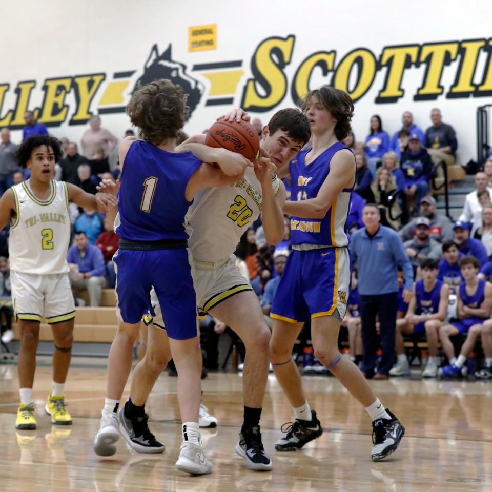 Aaron Frueh fights with West Muskiungum's Jacob Allen, left, for a rebound during the first half of Tri-Valley's 49-46 win on Tuesday night in Dresden. 