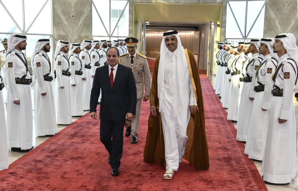In this photo provided by Egypt's presidency media office, Qatari Emir Tamim bin Hamad Al Thani, right, accompanies Egyptian President Abdel-Fattah el-Sissi, on his arrival in Doha, Qatar, Tuesday, Sept.13, 2022. Egypt’s president travelled on Tuesday to Qatar on his first visit to the gas-rich nation amid warming ties after years of frayed relations following the Egyptian military’s overthrow of an Islamist president backed by Doha.(Egyptian Presidency Media Office via AP)