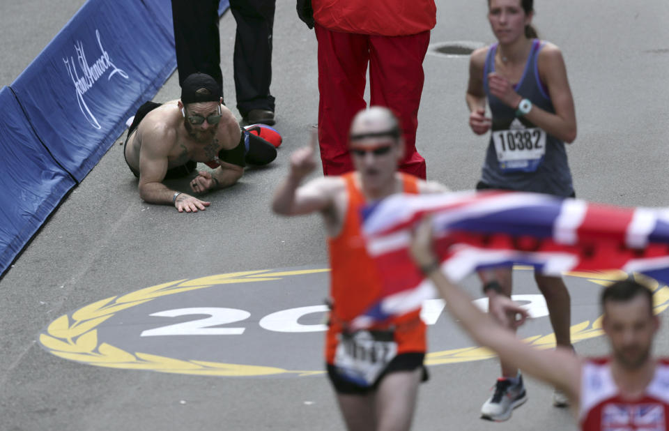 Micah Herndon, who crawled over the Boston Marathon finish line last year while honoring his fallen comrades, will compete in the race again in April. (AP/Charles Krupa)
