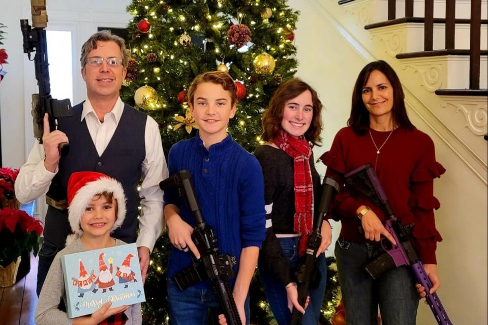 Andy Ogles poses with his family brandishing assault rifles in the Christmas photograph from 2021   (Facebook)