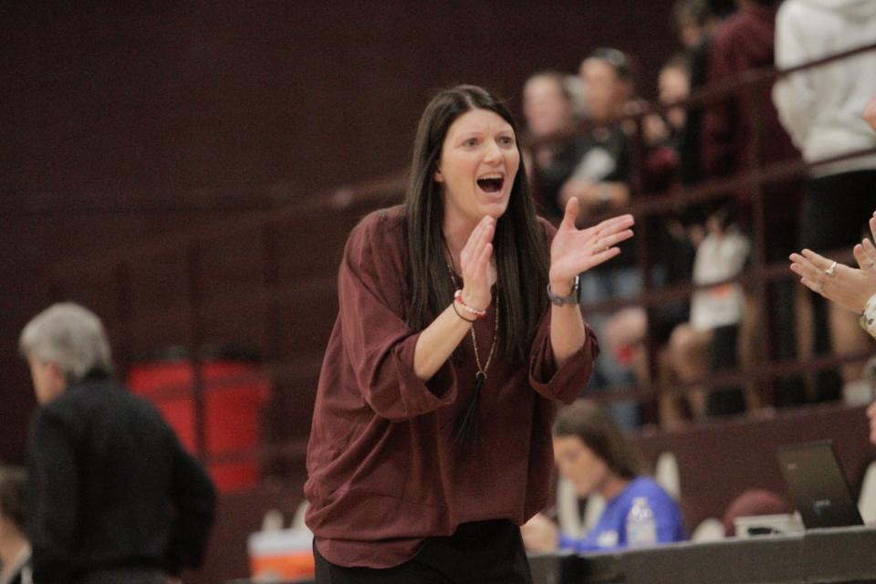 Brownwood girls basketball head coach Heather Hohertz claps after clinching a win over Lampasas.