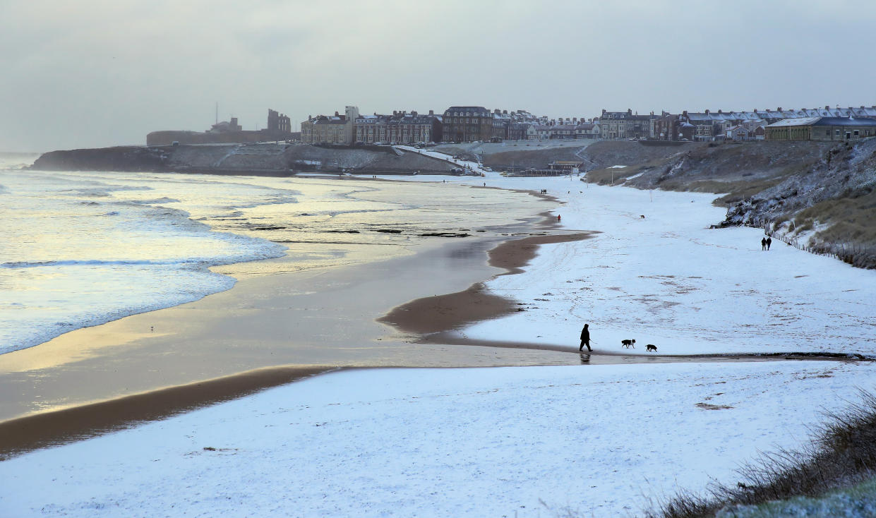 The sand turned white on Tynemouth beach on the North East coast yesterday following snow showers (PA)