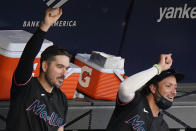 Miami Marlins players react from the dugout after teammate Chad Wallach got a base hit during the sixth inning of a baseball game against the New York Yankees, Sunday, Sept. 27, 2020, at Yankee Stadium in New York. (AP Photo/Kathy Willens)