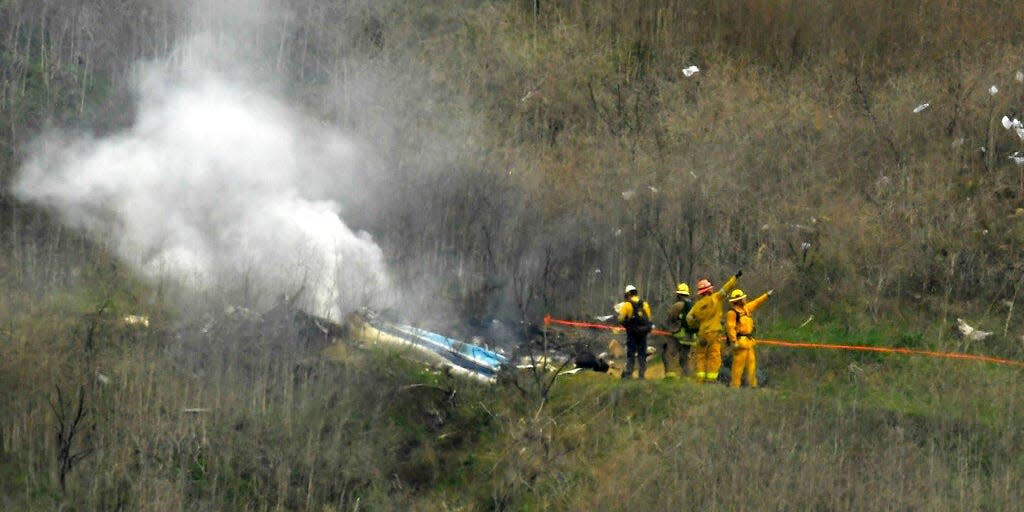 Firefighters work the scene of a helicopter crash where former NBA basketball star Kobe Bryant died in Calabasas, Calif., Jan. 26, 2020.