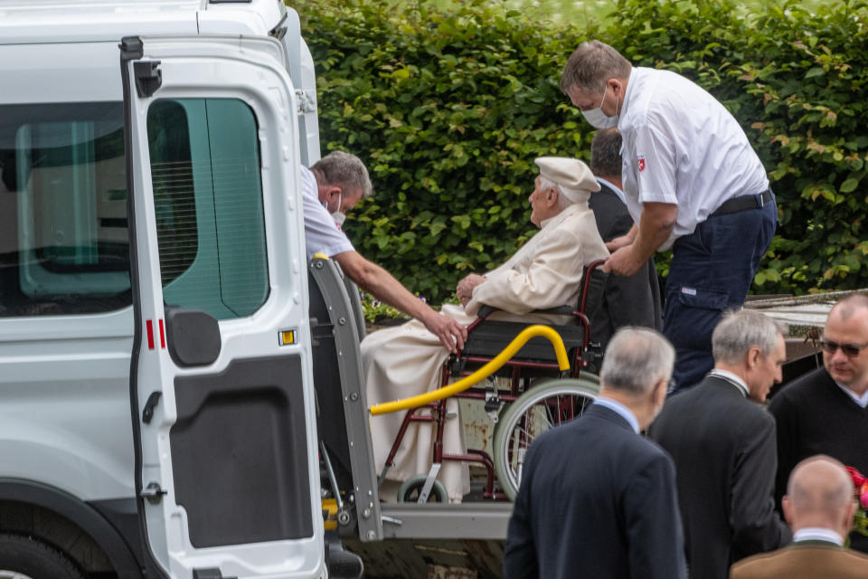 20 June 2020, Bavaria, Regensburg: The emeritus Pope Benedict XVI is driven from a bus in a wheelchair. Benedict will stay at least for the weekend in his old home country. Photo: Armin Weigel/dpa (Photo by Armin Weigel/picture alliance via Getty Images)