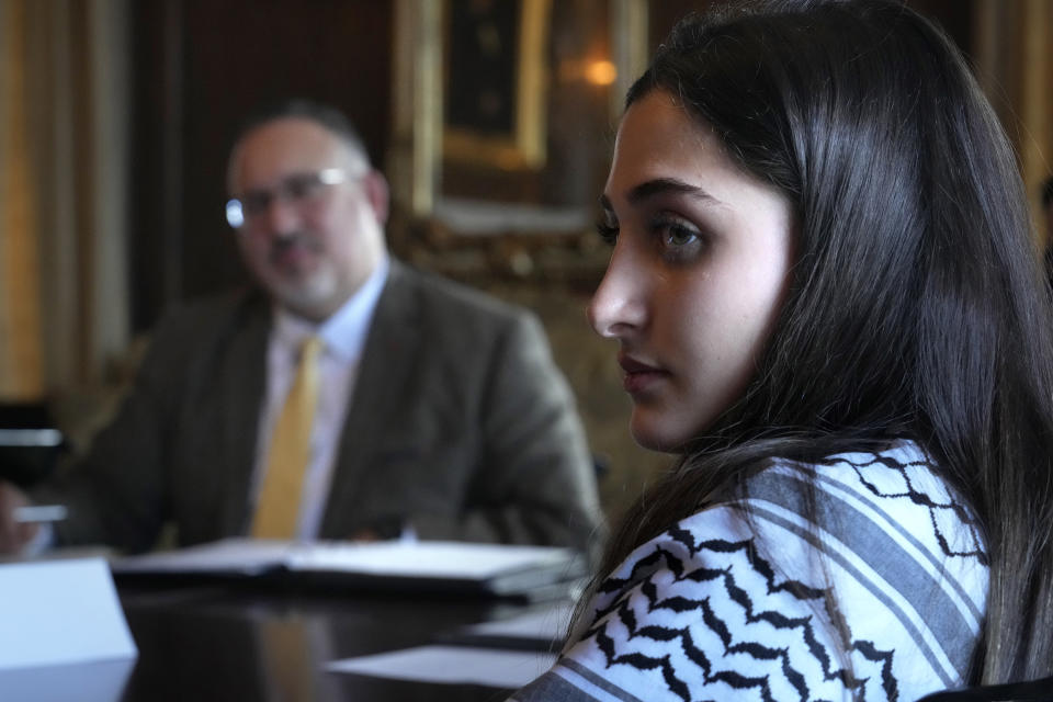 Dartmouth College student Yasmine Abouali, of Palestinian Tunisian heritage, right, and U.S. Education Secretary Miguel Cardona, behind left, participate in a roundtable discussion, Wednesday, Jan. 10, 2024, on the Dartmouth College campus, in Hanover, N.H. Fallout from the Israel-Hamas war has roiled campuses across the U.S. and reignited a debate over free speech. (AP Photo/Steven Senne)