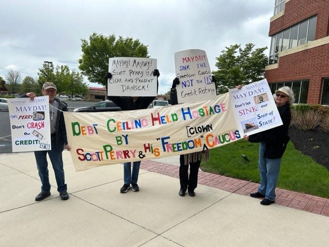 Members of 10th District Network staged a protest May 1 at U.S. Rep. Scott Perry's district office in Mechanicsburg. Protesters said they were told by a building manager they could not protest on the property.
