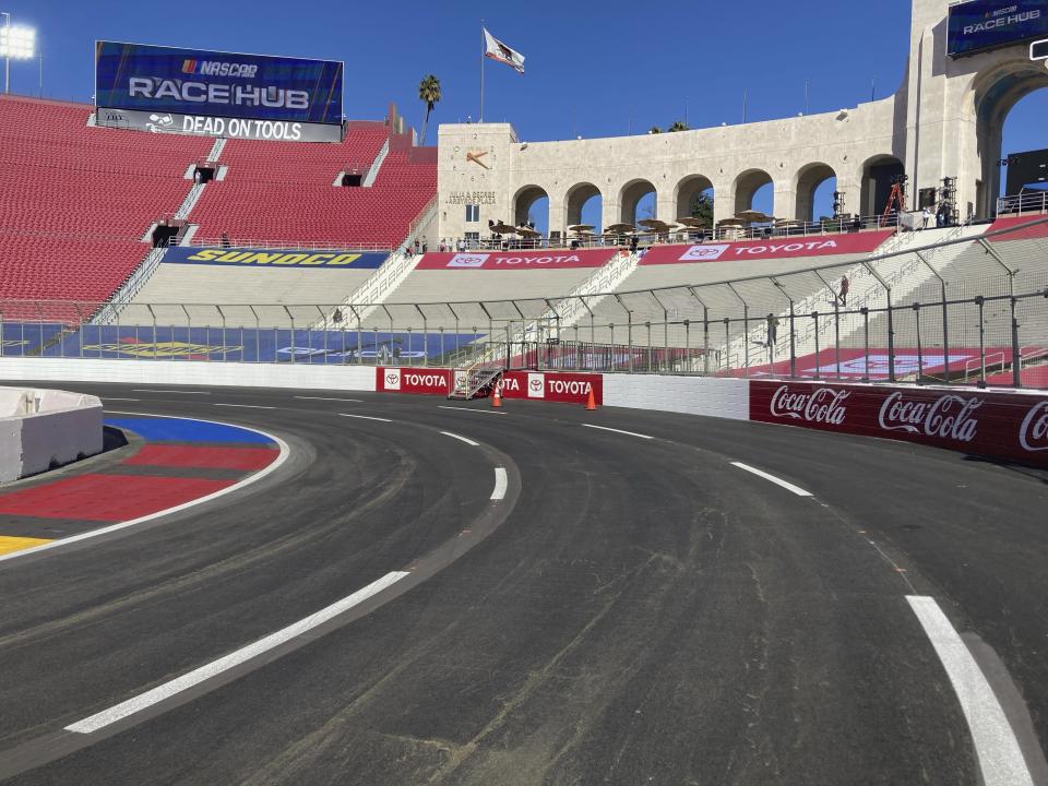 Turn 1 of a temporary auto racing track is viewed inside LA Coliseum ahead of a NASCAR exhibition race in Los Angeles, Friday, Feb. 4, 2022. NASCAR is hitting Los Angeles a week ahead of the Super Bowl, grabbing the spotlight with its wildest idea yet: The Clash, the unofficial season-opening, stock-car version of the Pro Bowl, will run at the iconic coliseum in a made-for-Fox Sports spectacular. (AP Photo/Jenna Fryer)