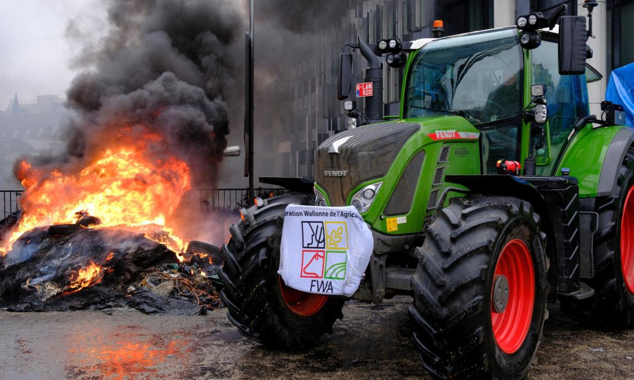 <span>Farmers burned tyres on Monday in a protest in the heart of the EU district in Brussels.</span><span>Photograph: Thierry Monasse/Getty Images</span>