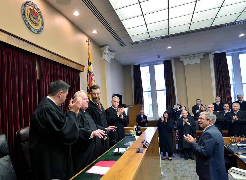 Kirk C. Downey is welcomed to the bench after being sworn in Friday as an associate judge for the Washington County Circuit Court. Standing at the bench, from left to right, are: Downey's best friend and a North Carolina judge, Thomas B. Langan; Downey; Washington County Circuit Court Administrative Judge Brett R. Wilson; and Chief Justice Matthew Fader of the Supreme Court of Maryland.