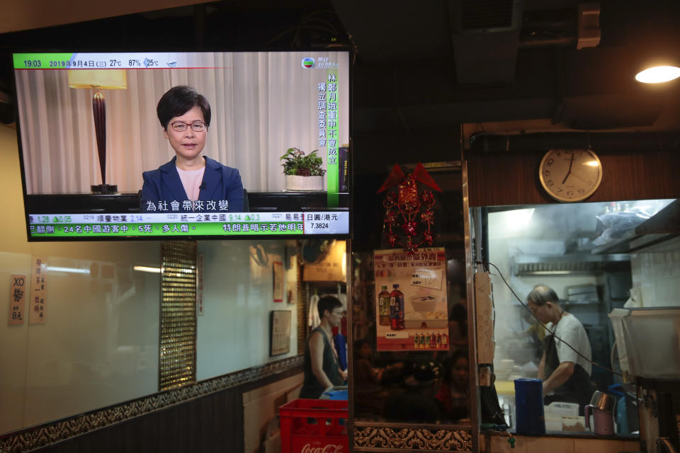 Hong Kong Chief Executive Carrie Lam makes an announcement on an extradition bill in television message, seen at a restaurant in Hong Kong, on Wednesday, Sept. 4, 2019. Hong Kong Chief Executive Lam has announced the government will formally withdraw an extradition bill that has sparked months of demonstrations in the city, bowing to one of the protesters' demands. The bill would have allowed Hong Kong residents to be sent to mainland China for trials. It sparked massive protests that have become increasingly violent and caused the airport to shut down earlier this month.(AP Photo/Jae C. Hong)