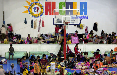 Evacuees from the coastal villages take shelter inside an evacuation center as Typhoon Haima locally name Lawin approaches, in Alcala town, Cagayan province, north of Manila October 19, 2016. REUTERS/Stringer