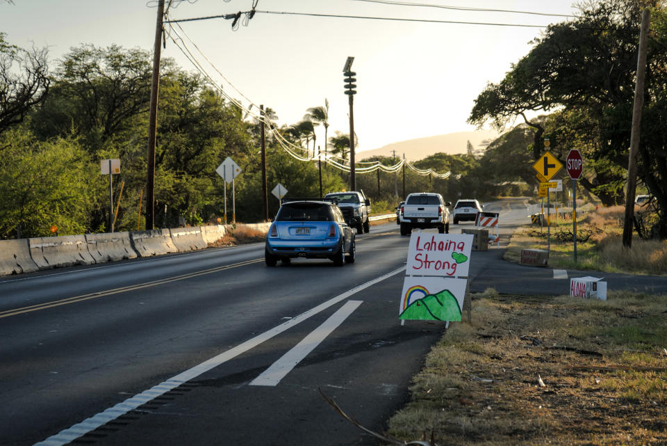 Cars drive by a “Lahaina strong” sign on Honoapiilani Highway, heading into Lahaina, Maui, Hawaii, on Aug. 16, 2023 (Josiah Patterson for NBC News)