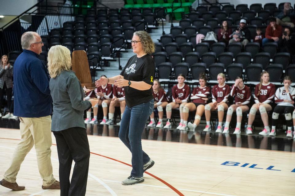 Sand Rock coach Lisa Bates accept the runner-up trophy during the Class 2A volleyball state championship at Bill Harris Arena in Birmingham, Ala., on Wednesday, Nov. 1, 2023.