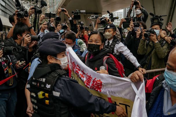 PHOTO: Photographers take picture of the members of League of Social Democrats scuffling with police outside the West Kowloon Magistrates' Courts ahead of the national security trail for the pro-democracy activists in Hong Kong, Feb. 6, 2023. (Anthony Kwan/AP)