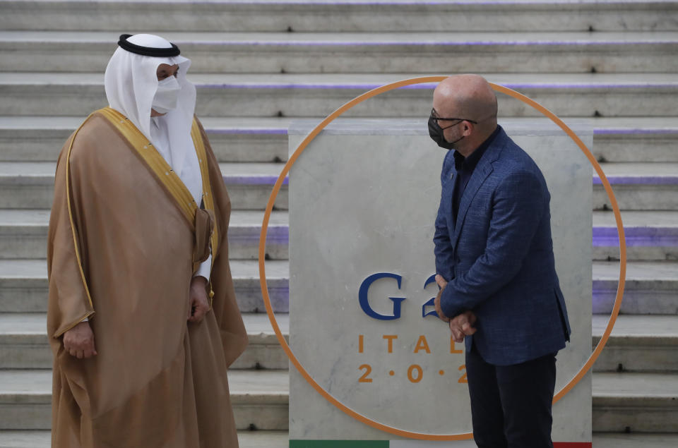 Saudi Arabia Minister of Environment, Water and Agriculture Abdulrahman Abdulmohsen A. AlFadley is welcomed by Italian Minister for Ecological Transition Roberto Cingolani, right, as he arrives at Palazzo Reale in Naples, Italy, Thursday, July 22, 2021, to take part in a G20 meeting on environment, climate and energy. (AP Photo/Salvatore Laporta)