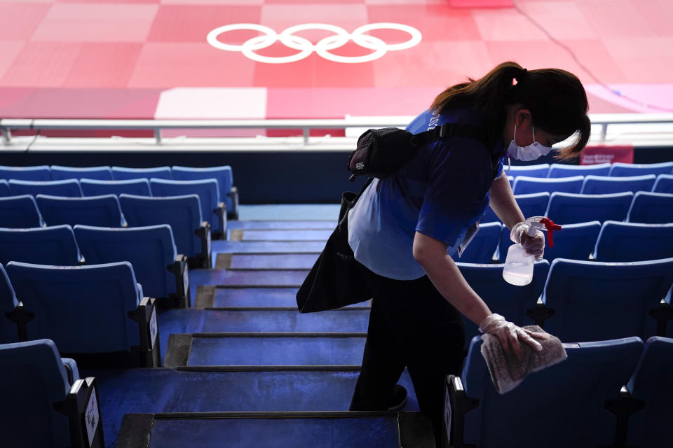 FILE - In this July 24, 2021, file photo, worker disinfects the seats before judo matches at the 2020 Summer Olympics in Tokyo, Japan. (AP Photo/Jae C. Hong, File)