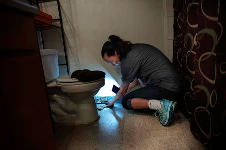 FILE PHOTO: Leanne Bell, 39, displays mold-lined baseboards at the army base housing allocated to her family in Fort Hood, Texas, U.S. May 16, 2019. Bell and her family say they began suffering breathing issues, depression, hair loss, and rashes while living in the home. They contacted housing maintenance repeatedly, submitting between 2 to 3 dozen work orders related to mold, HVAC, and air issue quality concerns over the course of 3 years. Picture taken May 16, 2019. REUTERS/Amanda Voisard