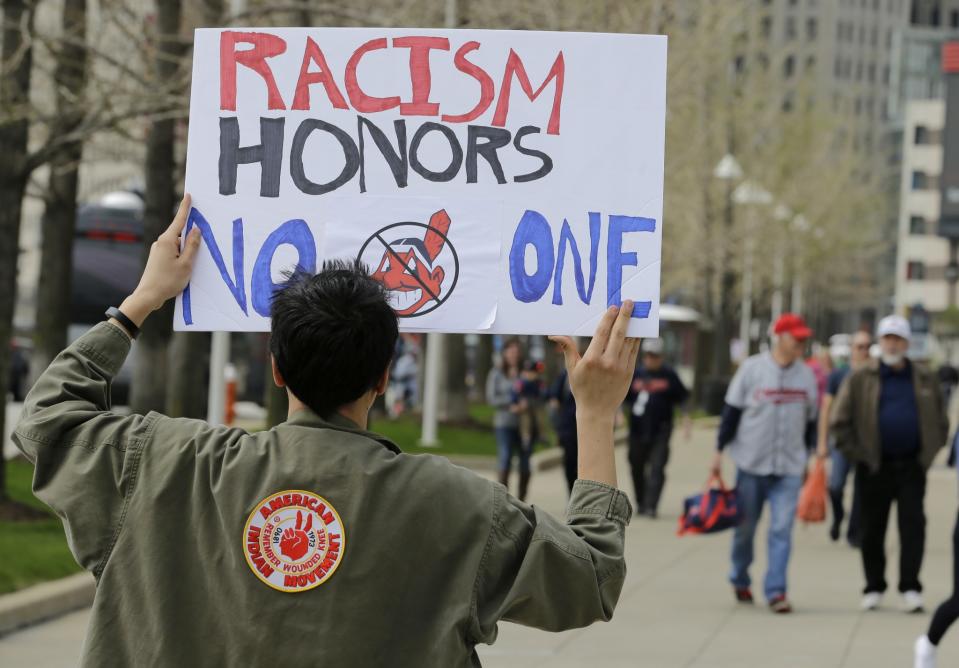 A protester outside of Progressive Field before the Indians' home opener. (AP)