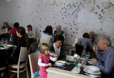 Guests sit in Izlelo, a restaurant in Szekszard, south of Budapest, September 22, 2014. REUTERS/Bernadett Szabo