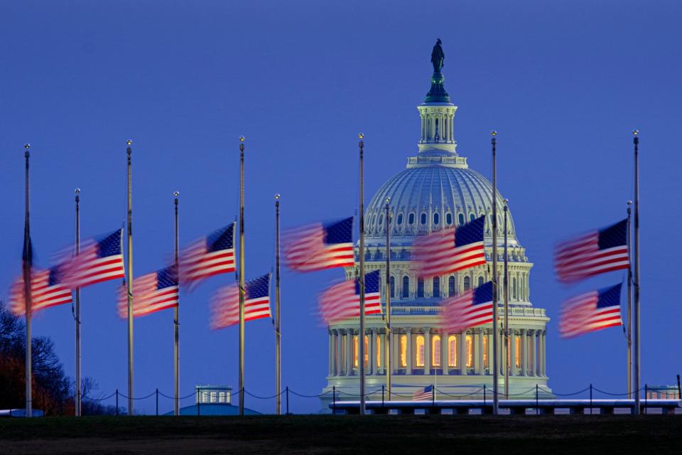Flags fly before dawn Dec. 6, 2021, on the National Mall in Washington, D.C.  The flags were at half-staff in honor of former Sen. Bob Dole.