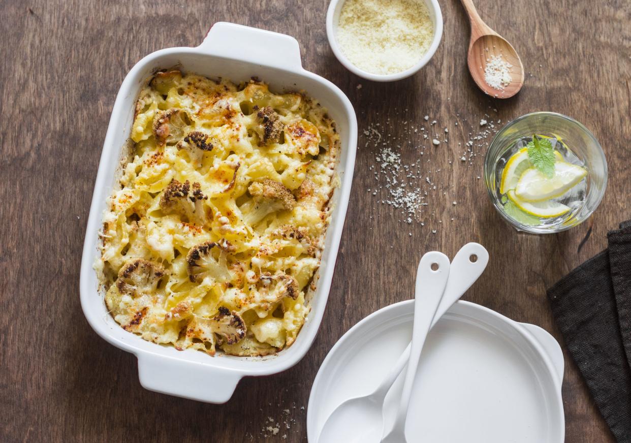 Cauliflower mac and cheese on the brown wooden table, top view