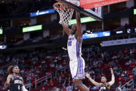 Sacramento Kings forward Harrison Barnes (40) dunks between Houston Rockets guard Jalen Green (4) and Houston Rockets forward K.J. Martin, right, during the first half of an NBA basketball game Monday, Feb. 6, 2023, in Houston. (AP Photo/Michael Wyke)