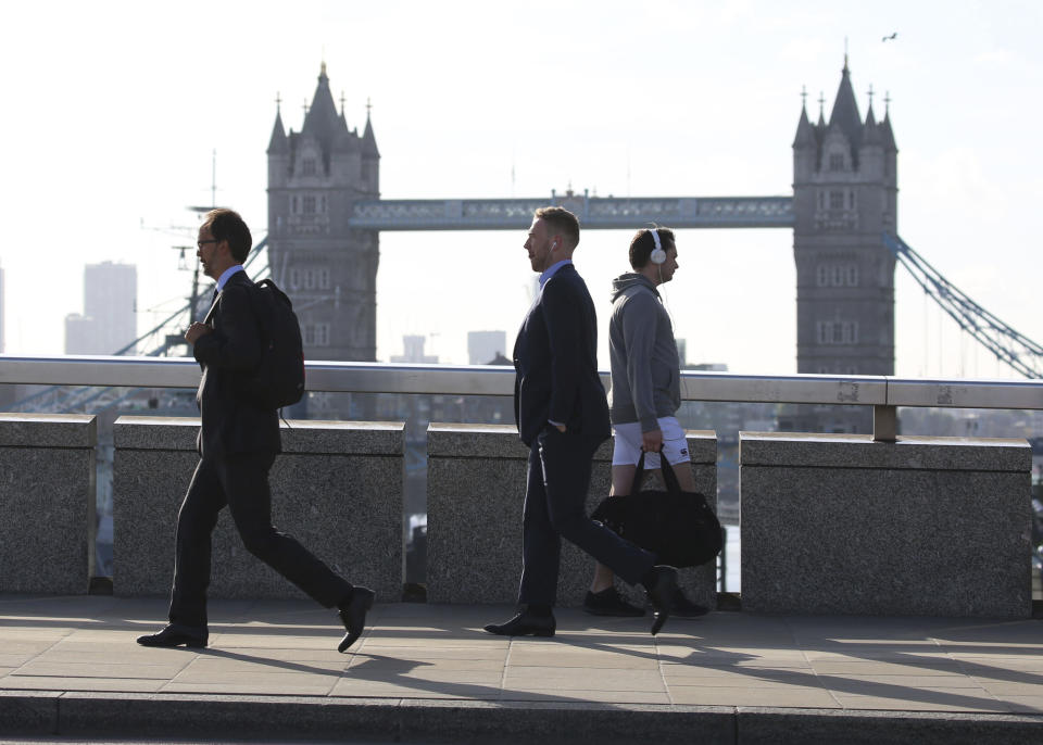 Commuters cross London Bridge, which has reopened after Saturday evening's terror attack, in London Monday, June 5, 2017. London police have raided two addresses and detained "a number" of people suspected of some connection to the Saturday night car attack and knife rampage on London Bridge. (Isabel Infantes/PA via AP)