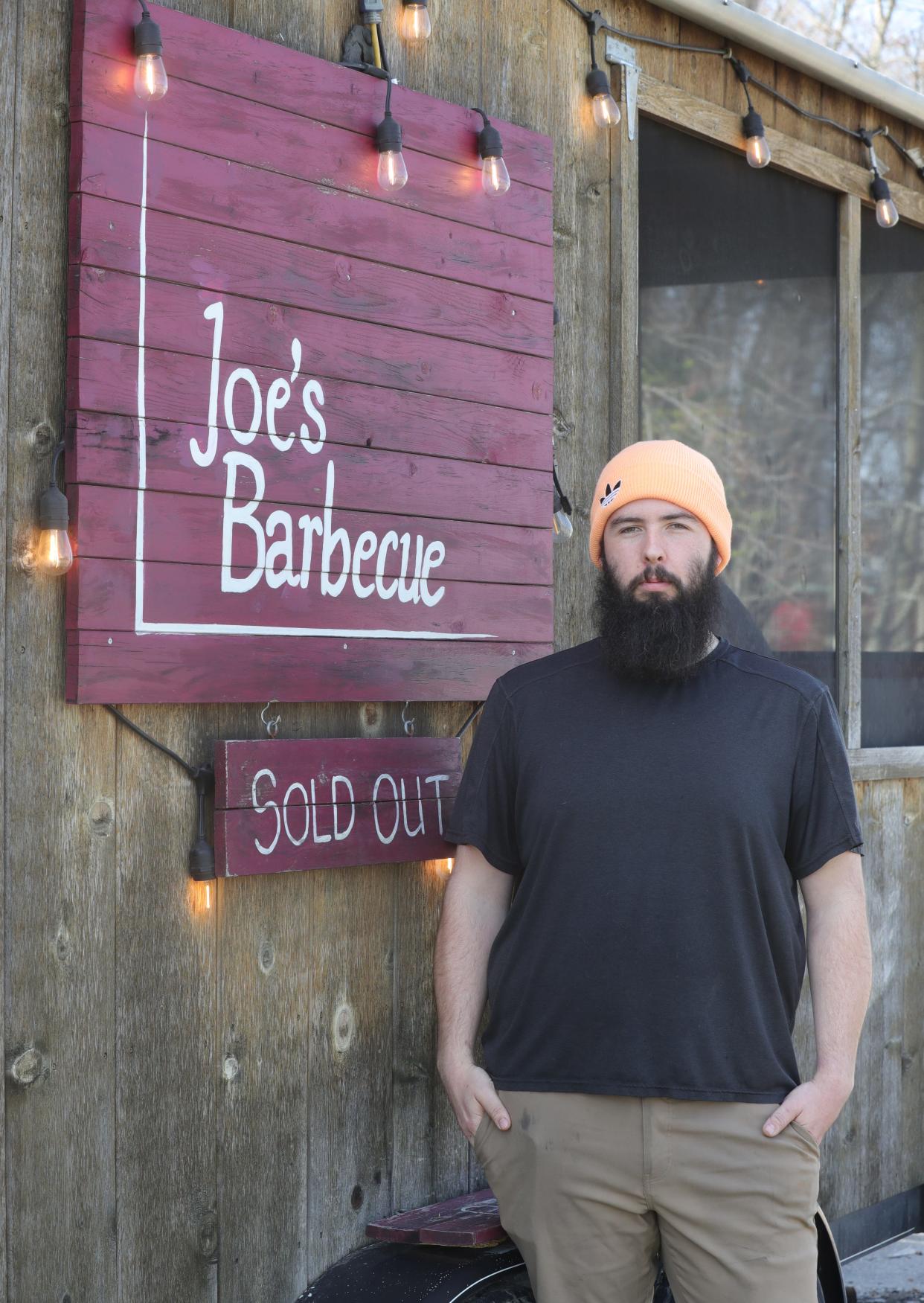 Joe Menendez, owner of Joe's Barbecue, stands outside his food truck business in Brimfield Township.