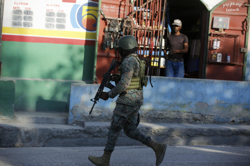 A soldier patrols the outskirts of the international airport in Port-au-Prince, Haiti, Monday, March 4, 2024. Gang members exchanged gunfire with police and soldiers around the airport in the latest of a series of attacks on government sites that includes a mass escape from the country's two biggest prisons. (AP Photo/Odelyn Joseph)