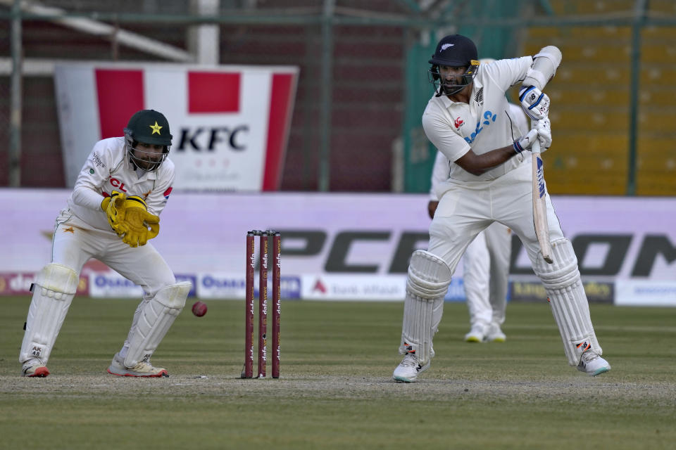 New Zealand's Ish Sodhi, right, plays a shot as Pakistan's Sarfraz Ahmed watches during the fourth day of first test cricket match between Pakistan and New Zealand, in Karachi, Pakistan, Thursday, Dec. 29, 2022. (AP Photo/Fareed Khan)