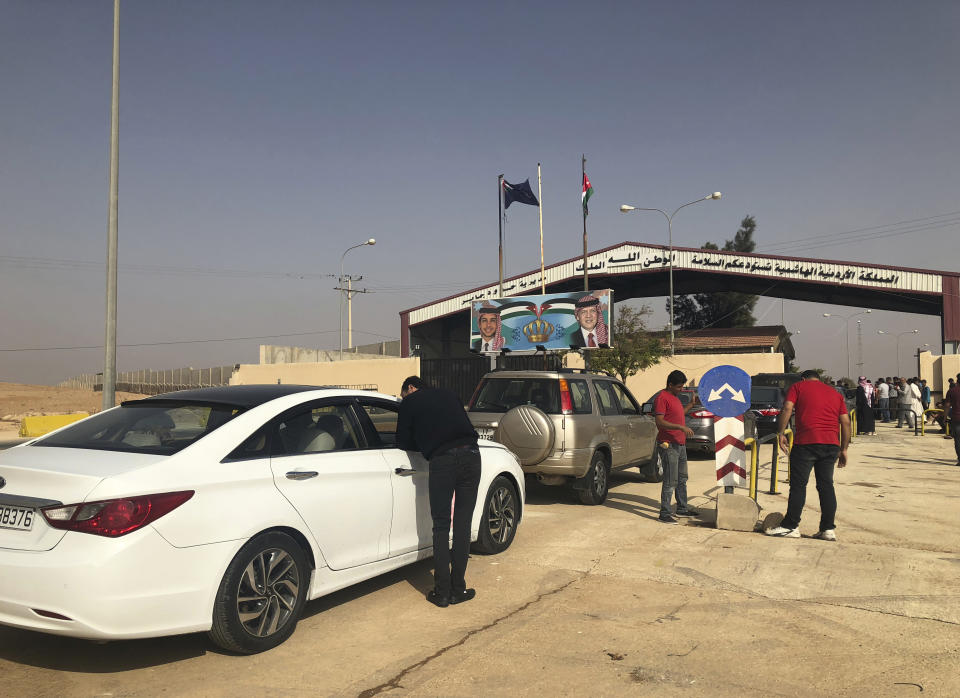 Jordanian cars prepare to cross into Syria, at the Jordanian-Syrian border Jaber crossing point, in Mafraq, Jordan, Monday, Oct. 15, 2018. A vital border crossing linking Syria and Jordan has reopened for the first time in three years, promising to restore commercial trade and travel between the two countries. (AP Photo/Omar Akour)